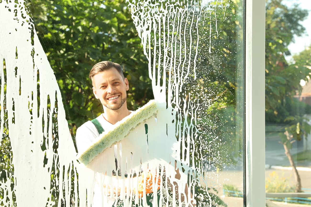 A GlassPro crew member cleaning home windows